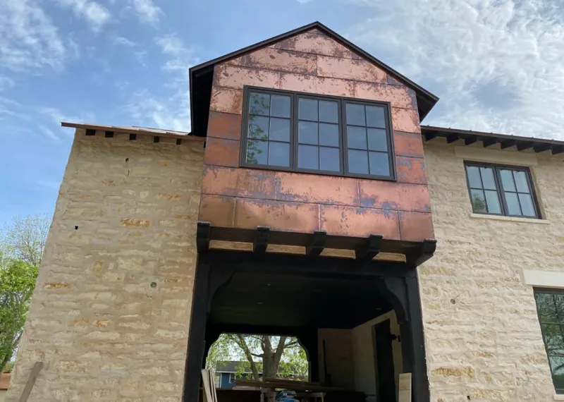 Copper metal panel facade on a stone building for Skylight Installation in La Cresta